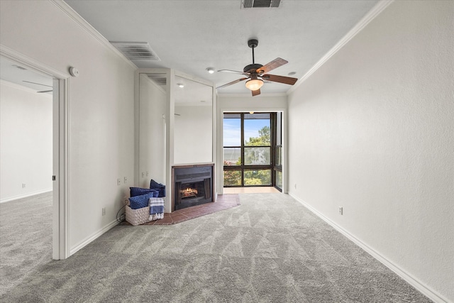 unfurnished living room featuring carpet flooring, crown molding, and ceiling fan