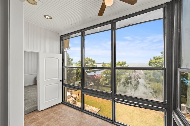 unfurnished sunroom with ceiling fan