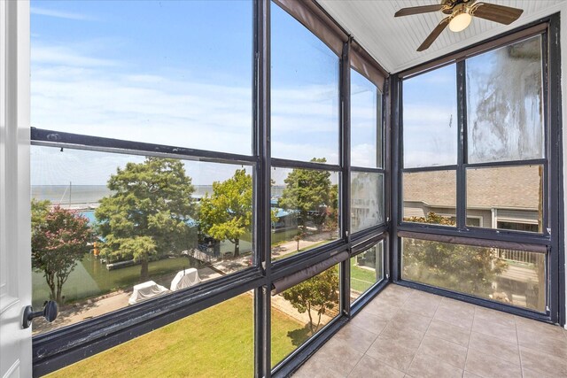 unfurnished sunroom with ceiling fan