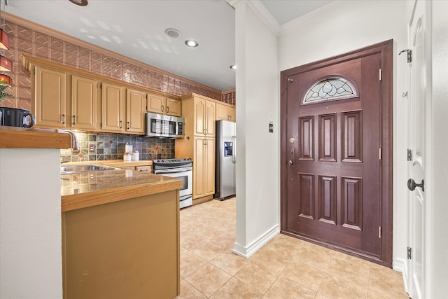 kitchen with crown molding, sink, decorative backsplash, light tile patterned floors, and appliances with stainless steel finishes