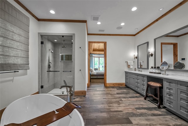 bathroom with crown molding, vanity, independent shower and bath, and hardwood / wood-style flooring