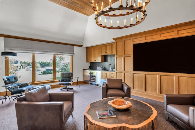 carpeted living room featuring high vaulted ceiling, sink, beverage cooler, and an inviting chandelier