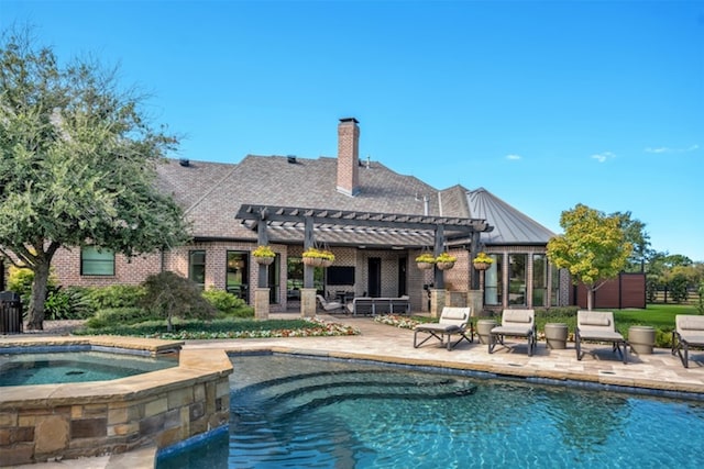 back of house with a pergola, a patio, and a pool with hot tub