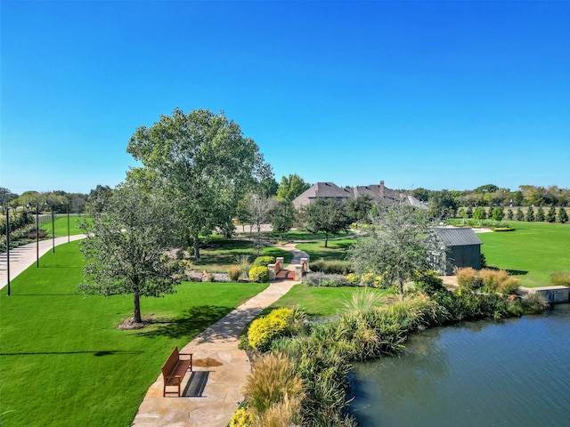 view of community featuring a lawn and a water view