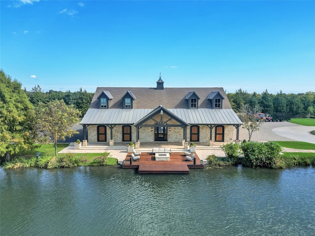 back of property featuring a water view