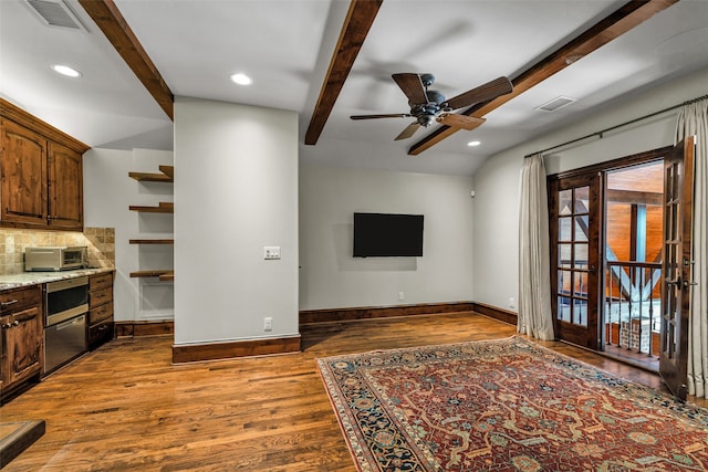 living room featuring vaulted ceiling with beams, ceiling fan, and dark hardwood / wood-style floors