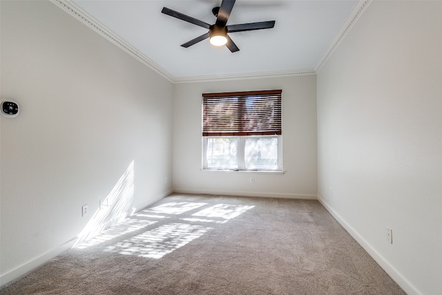 carpeted spare room featuring ceiling fan and ornamental molding