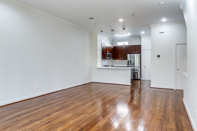 unfurnished living room featuring dark hardwood / wood-style flooring and ornamental molding