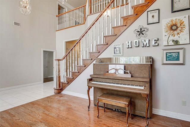 interior space with a notable chandelier, a high ceiling, and hardwood / wood-style flooring