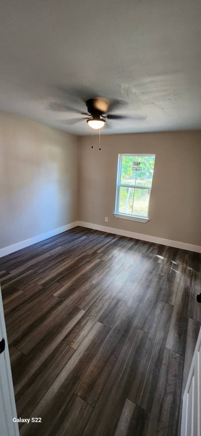 spare room with dark hardwood / wood-style floors and ceiling fan