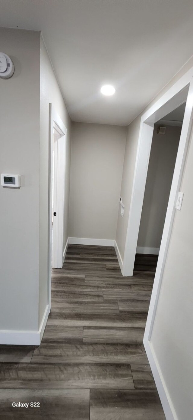 hall with dark hardwood / wood-style flooring