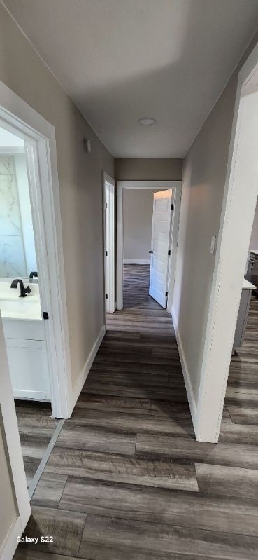 corridor featuring dark hardwood / wood-style flooring