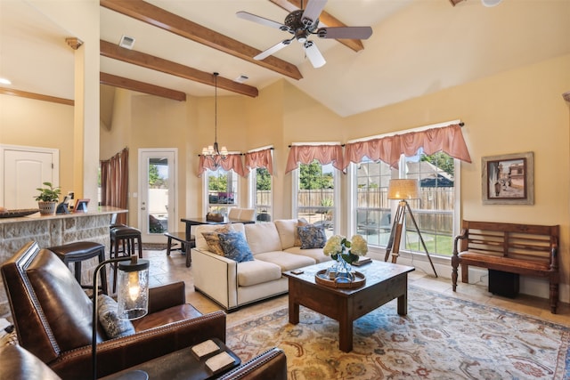 living room featuring plenty of natural light, beam ceiling, ceiling fan with notable chandelier, and high vaulted ceiling