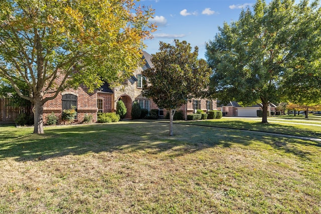 obstructed view of property with a front yard