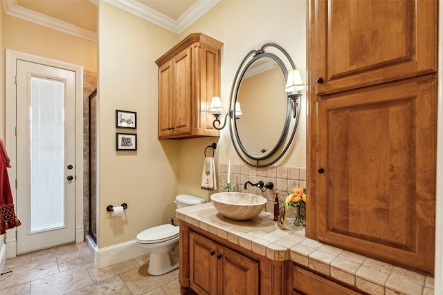 bathroom featuring vanity, crown molding, toilet, walk in shower, and tasteful backsplash