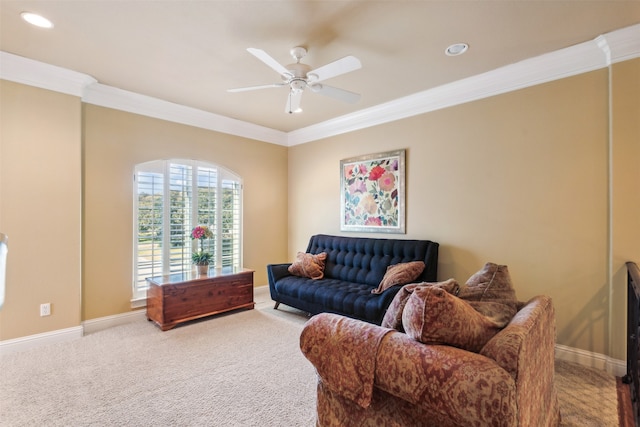 carpeted living room with ceiling fan and crown molding