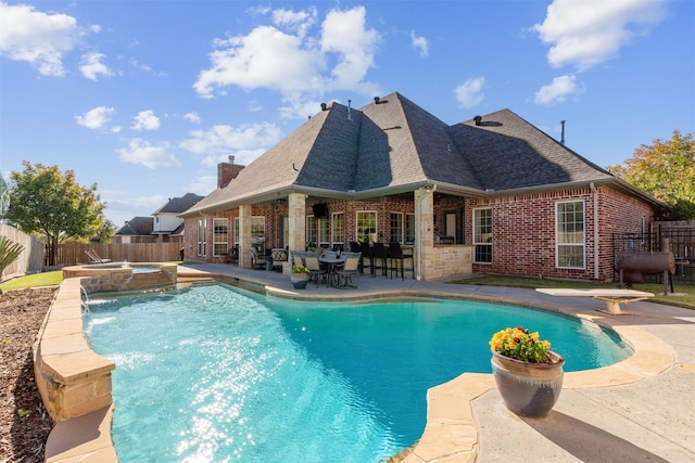 1123 Berkley Dr, Cleburne, TX 76033 - view of swimming pool with pool water feature, an in ground hot tub, and a patio