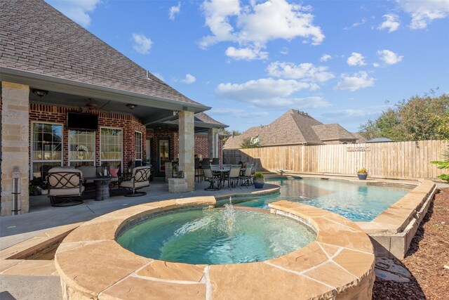 view of pool with a patio area and an in ground hot tub