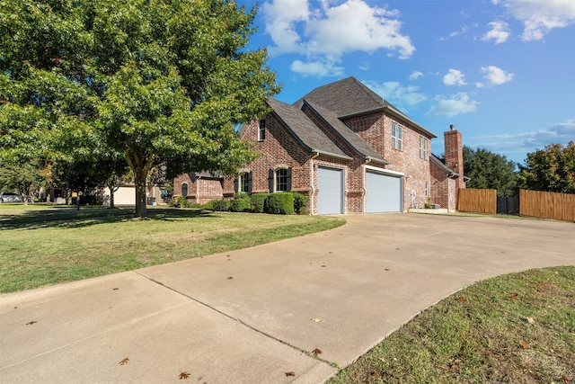 view of front of home featuring a front yard and a garage