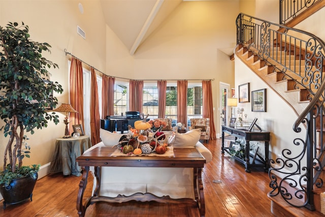 living room with high vaulted ceiling and wood-type flooring