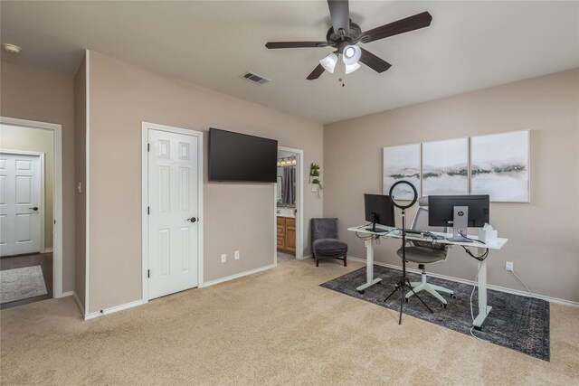 office featuring light carpet and ceiling fan