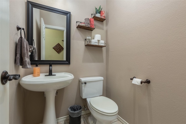 bathroom featuring tile patterned flooring and toilet