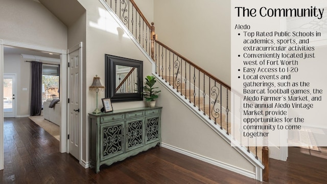 staircase with a towering ceiling and hardwood / wood-style flooring