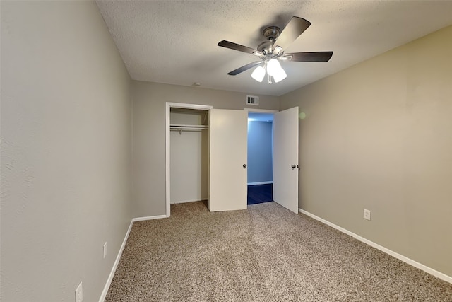 unfurnished bedroom featuring carpet flooring, ceiling fan, a closet, and a textured ceiling