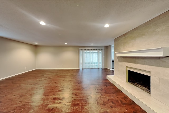 unfurnished living room featuring hardwood / wood-style floors and a tile fireplace