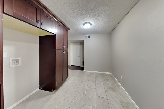 hall featuring a textured ceiling