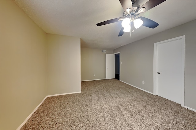 carpeted empty room with ceiling fan and a textured ceiling