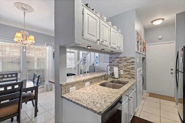 kitchen with sink, dishwashing machine, light tile patterned floors, decorative backsplash, and white cabinets