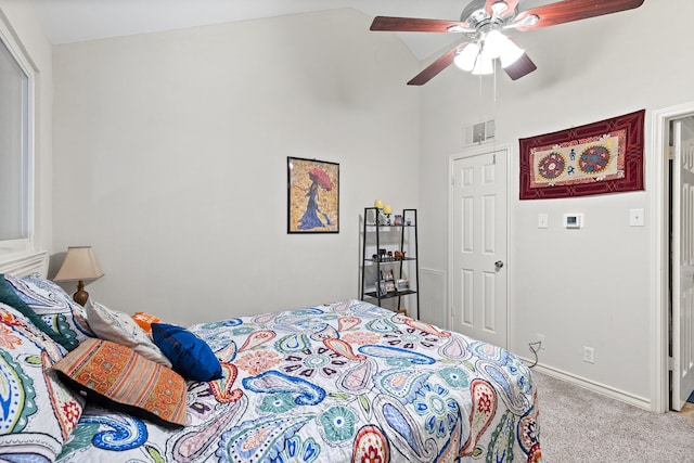 carpeted bedroom featuring vaulted ceiling and ceiling fan