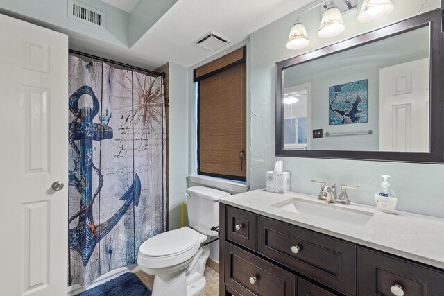 bathroom featuring vanity, a shower with shower curtain, and toilet