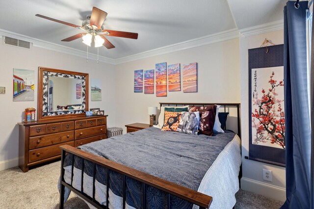 carpeted bedroom featuring ceiling fan and crown molding