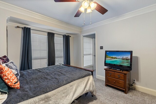 carpeted bedroom featuring ceiling fan and crown molding