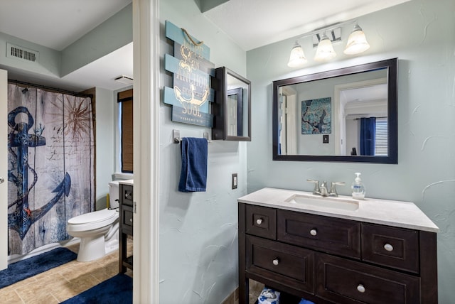 bathroom featuring vanity, a shower with shower curtain, and toilet