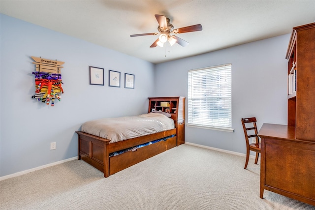 bedroom with ceiling fan and light carpet