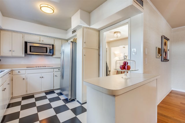 kitchen featuring white cabinets, light wood-type flooring, kitchen peninsula, and appliances with stainless steel finishes