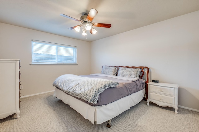 bedroom featuring light colored carpet and ceiling fan