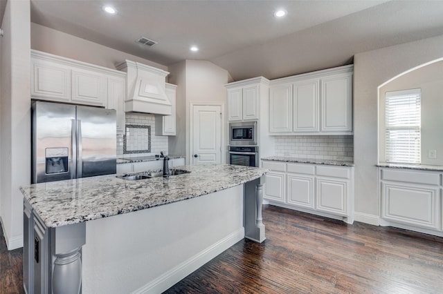 kitchen featuring white cabinetry, dark hardwood / wood-style floors, lofted ceiling, decorative backsplash, and appliances with stainless steel finishes