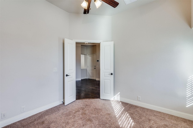 unfurnished room with ceiling fan and carpet floors