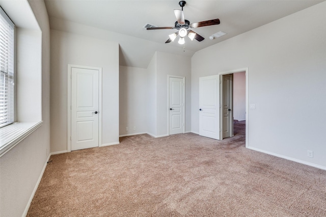 unfurnished bedroom with ceiling fan and light carpet