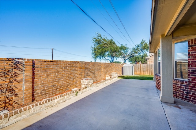 view of patio featuring a storage shed