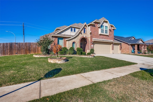 view of front of house with a front yard and a garage