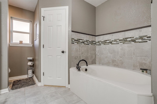 bathroom featuring a washtub and tile patterned flooring