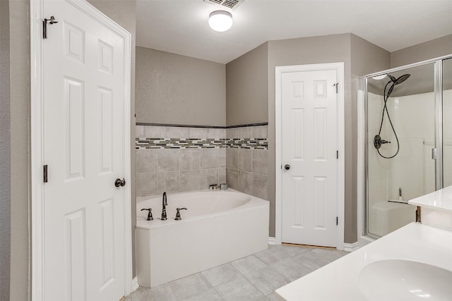 bathroom with tile patterned floors, a textured ceiling, sink, tile walls, and independent shower and bath