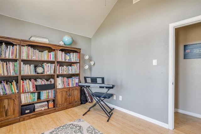 office space featuring lofted ceiling and light hardwood / wood-style flooring