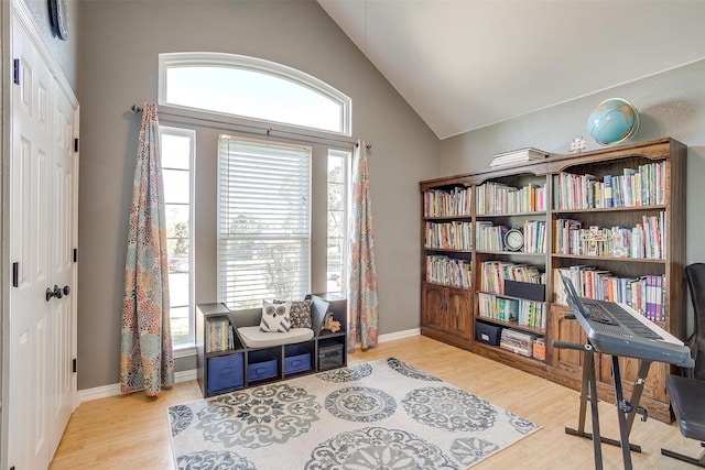 living area with vaulted ceiling and light hardwood / wood-style flooring