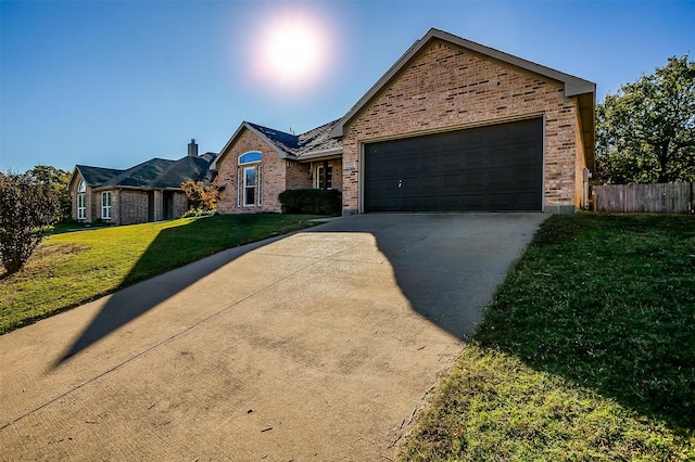 view of front of house featuring a front lawn and a garage